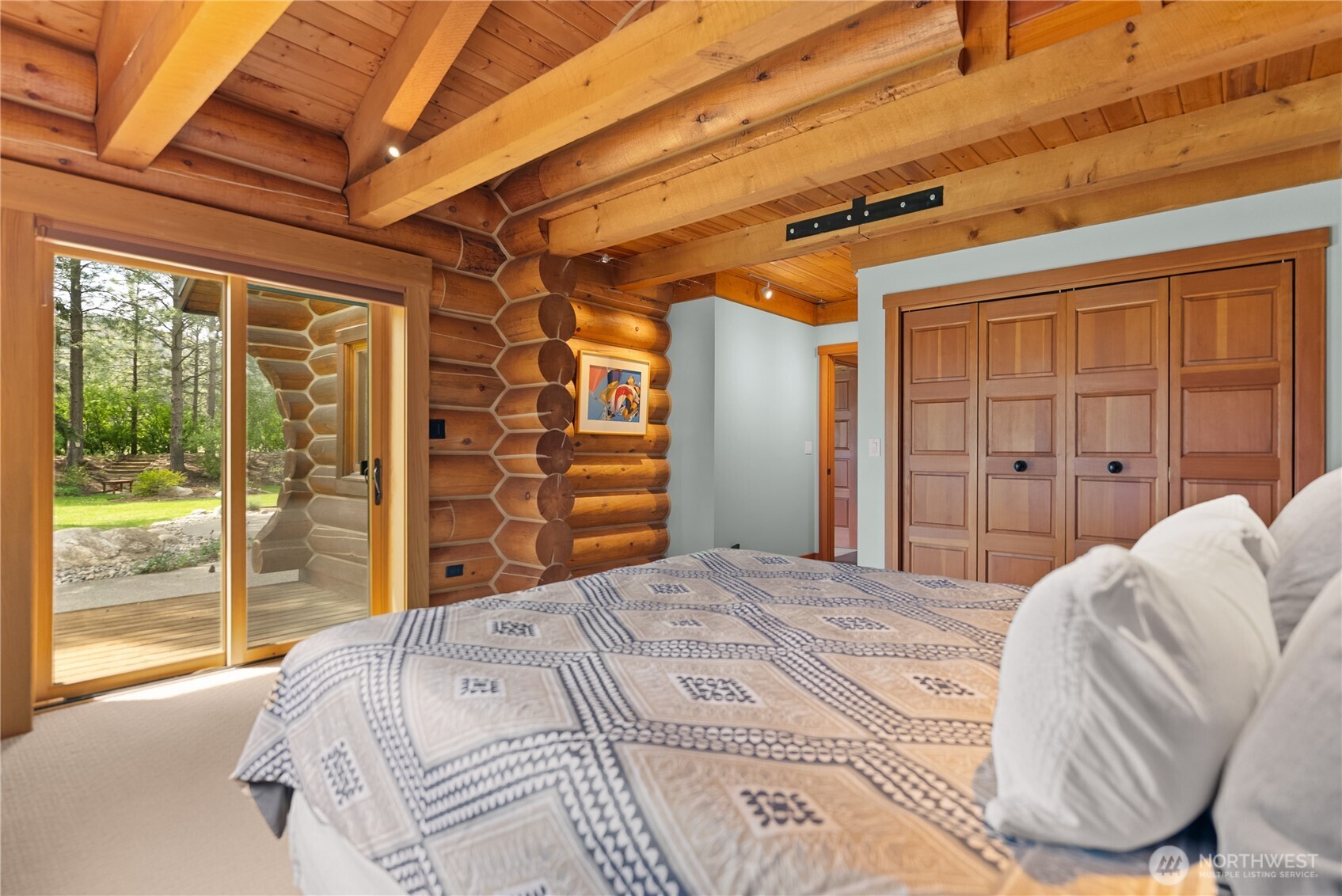 179 Wolf Creek Road Winthrop, WA 98862 - Photo 32 of 40 a bedroom with a bed and a large window