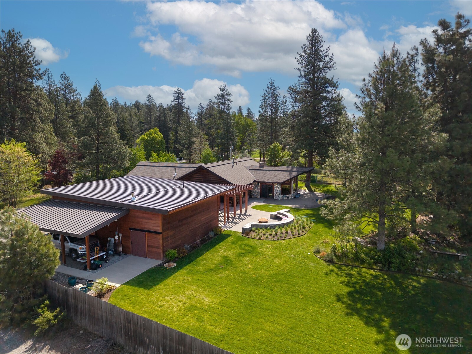 179 Wolf Creek Road Winthrop, WA 98862 - Photo 37 of 40 an aerial view of a house with swimming pool and trees in the background