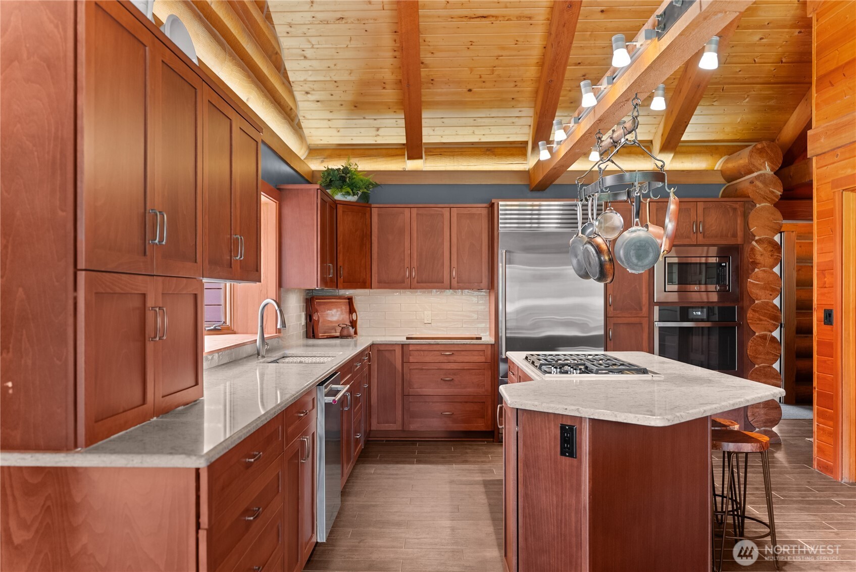 179 Wolf Creek Road Winthrop, WA 98862 - Photo 10 of 40 a kitchen with a sink refrigerator and cabinets