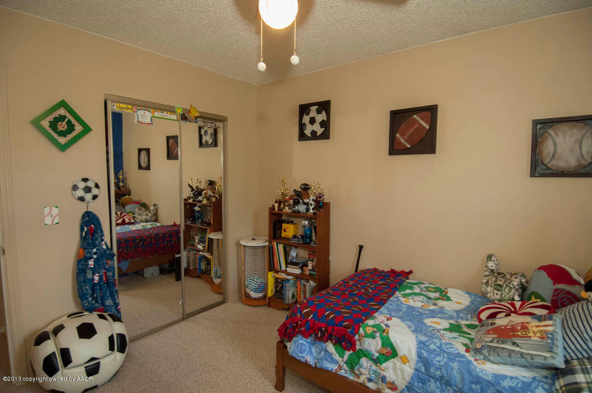 8212 Indian Trail Amarillo, TX 79110 - Photo 22 of 28 a bedroom with a bed and a chair
