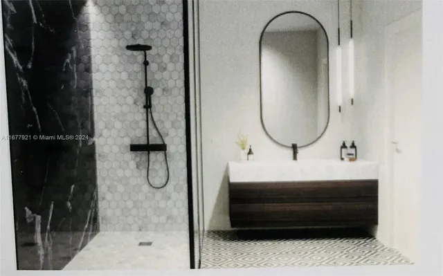 a bathroom with a sink a mirror and shower