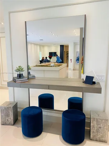 a living room with furniture and a mirror