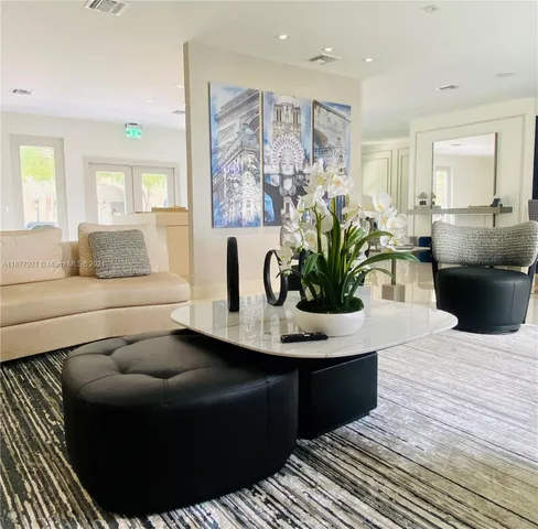 a living room with furniture and a large mirror