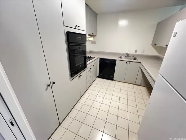 a room with a washing machine and cabinets