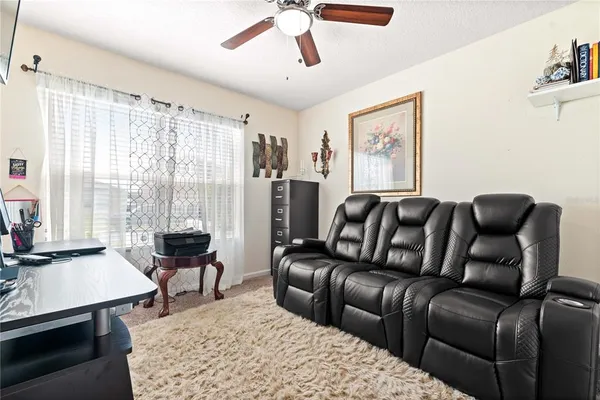 a living room with furniture and a large window