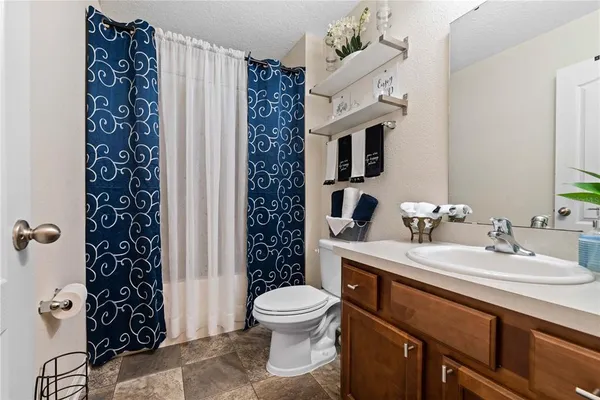 a bathroom with a sink toilet a mirror and shower