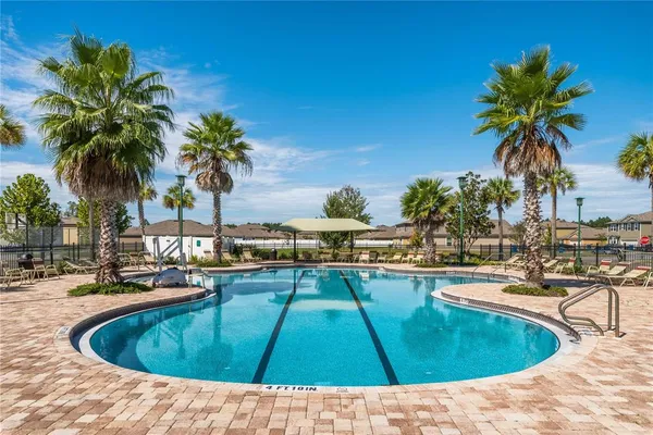 a view of swimming pool with chairs