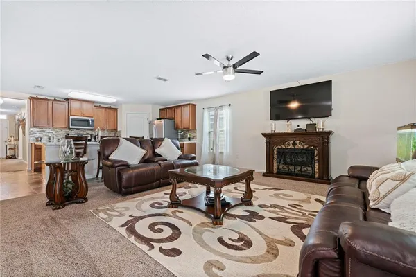 a living room with furniture a fireplace and a flat screen tv