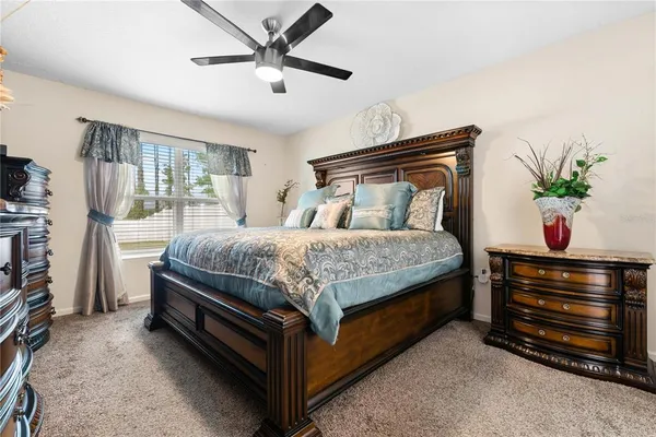 a bedroom with a bed and a potted plant