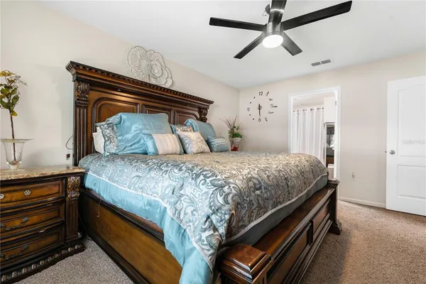 a bedroom with a bed and ceiling fan