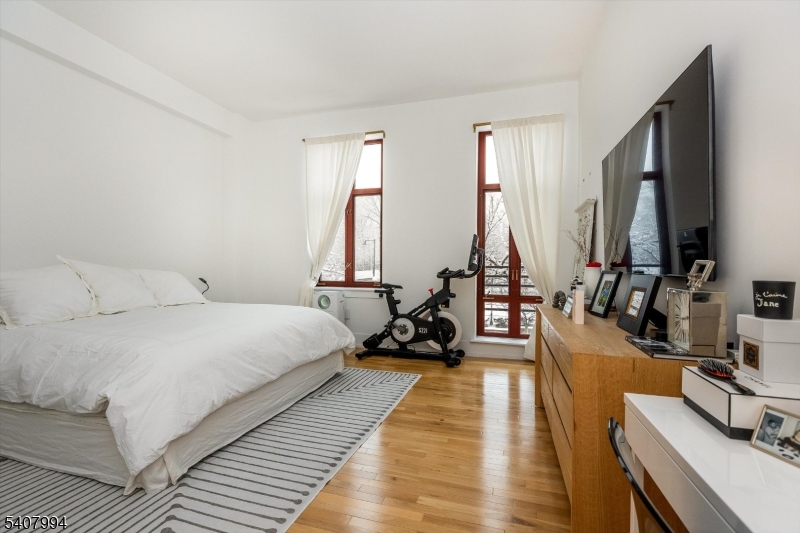 85 Park Avenue, Unit 205 Glen Ridge, NJ 07028 - Photo 20 of 37 a bed room with a bed and a flat screen tv