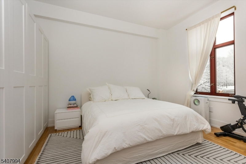 85 Park Avenue, Unit 205 Glen Ridge, NJ 07028 - Photo 21 of 37 a bedroom with a bed and a window