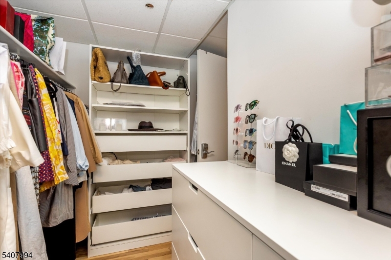 85 Park Avenue, Unit 205 Glen Ridge, NJ 07028 - Photo 26 of 37 a view of walk in closet with clothes and shoes