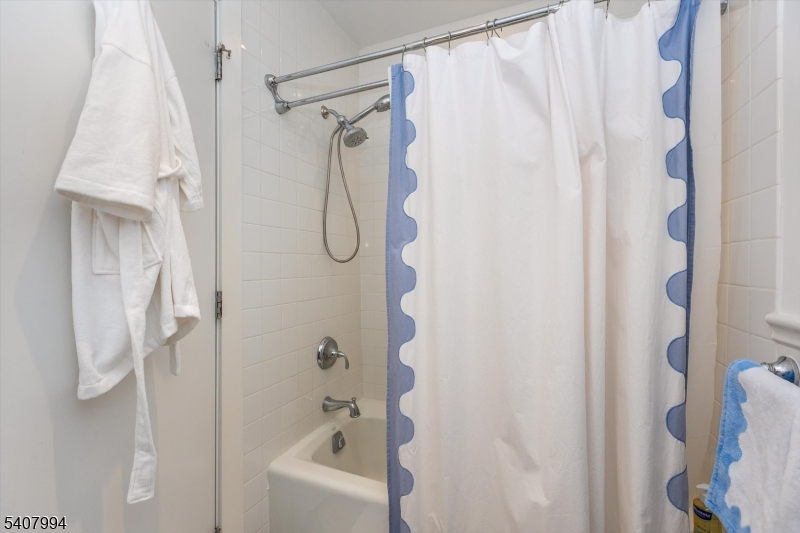 85 Park Avenue, Unit 205 Glen Ridge, NJ 07028 - Photo 32 of 37 a bathroom with a shower curtain and a shower