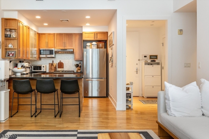 85 Park Avenue, Unit 205 Glen Ridge, NJ 07028 - Photo 8 of 37 a kitchen with stainless steel appliances a dining table chairs and refrigerator