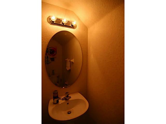 43 Southwest Squirrel Nest Way Stuart, FL 34997 - Photo 12 of 22 a view of a bathroom with a sink and mirror