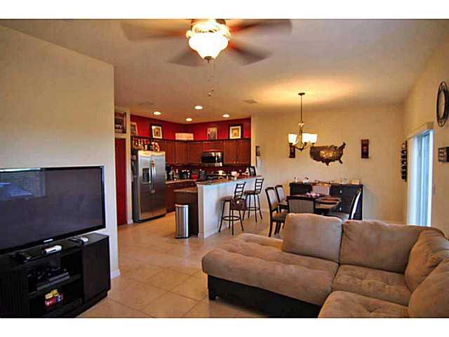 43 Southwest Squirrel Nest Way Stuart, FL 34997 - Photo 7 of 22 a living room with furniture kitchen and a chandelier