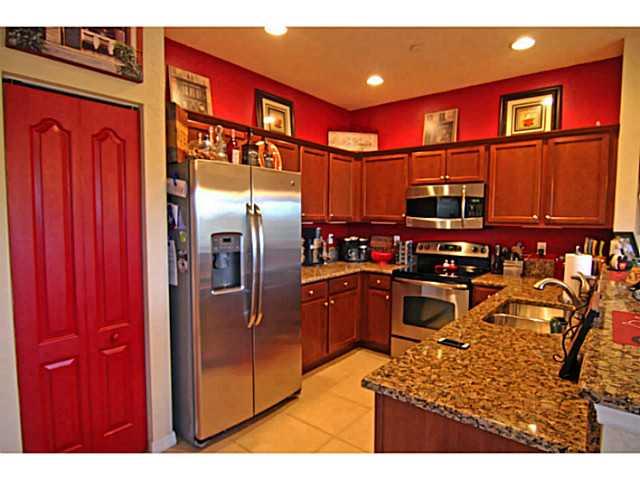 43 Southwest Squirrel Nest Way Stuart, FL 34997 - Photo 8 of 22 a kitchen with stainless steel appliances granite countertop a refrigerator and a sink