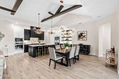a kitchen with granite countertop a sink a counter top space and stainless steel appliances