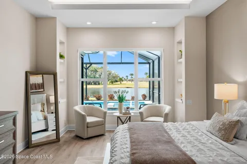 a living room with furniture a flat screen tv and a window
