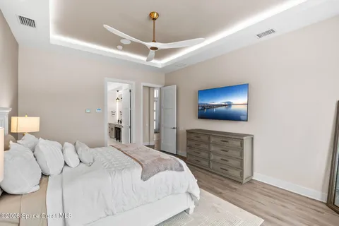 a bedroom with a bed and a lamp