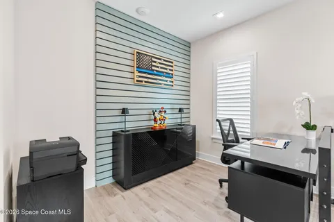 a dining room with furniture a rug and a floor to ceiling window
