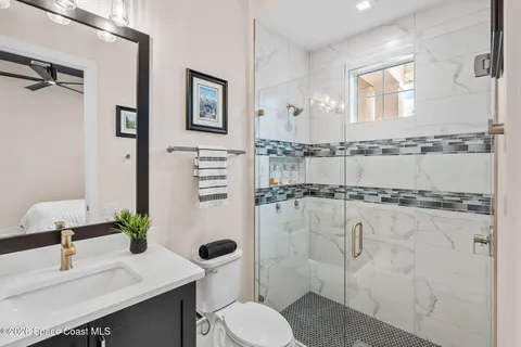 a view of a patio with a table and chairs under an umbrella