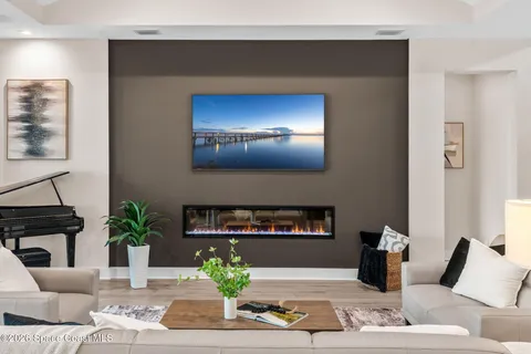 a living room with lots of furniture and kitchen view