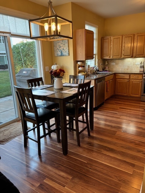 1433 White Pine Lane Bolingbrook, IL 60490 - Photo 6 of 25 a view of a dining room with furniture and wooden floor