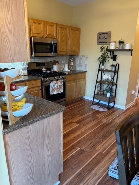 1433 White Pine Lane Bolingbrook, IL 60490 - Photo 8 of 25 a kitchen with stainless steel appliances granite countertop a sink stove and microwave