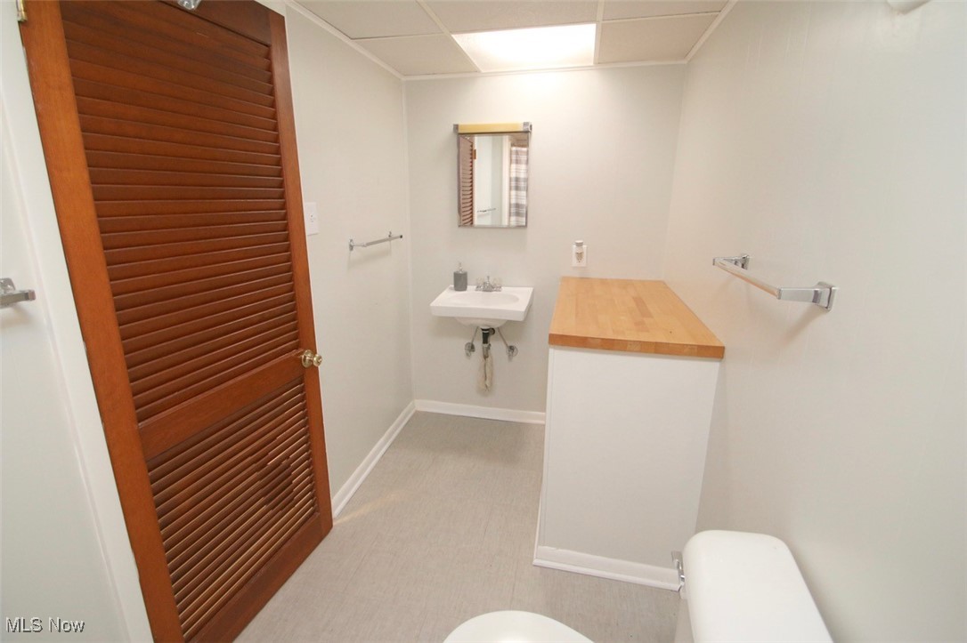 2802 South Ridge Road East Kingsville, OH 44048 - Photo 31 of 42 Half bathroom with toilet and a drop ceiling