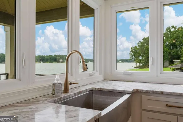 a kitchen with a sink and large window