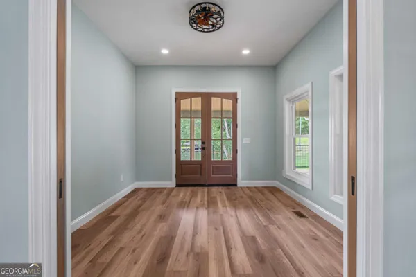 a view of an empty room and glass door
