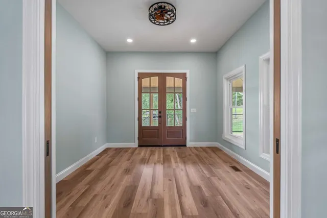 a view of an empty room and glass door