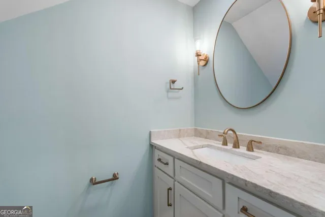 a bathroom with a sink and mirror