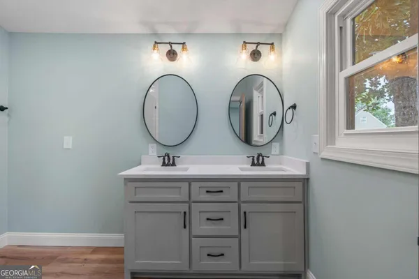 a bathroom with 2 sink and a mirror