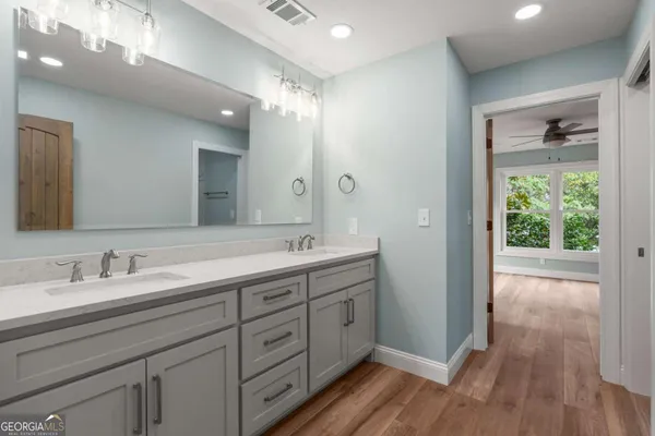 a spacious bathroom with a double vanity sink and a mirror