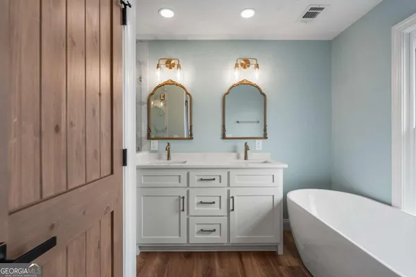 a bathroom with 2 sink and a mirror