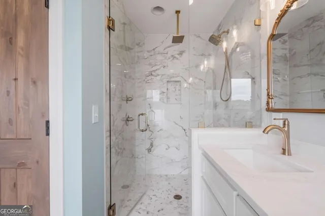 a bathroom with a sink a shower and a mirror