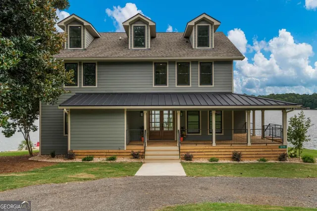 a front view of a house with a garden and garage