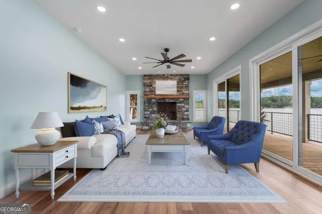 a living room with fireplace furniture and a large window