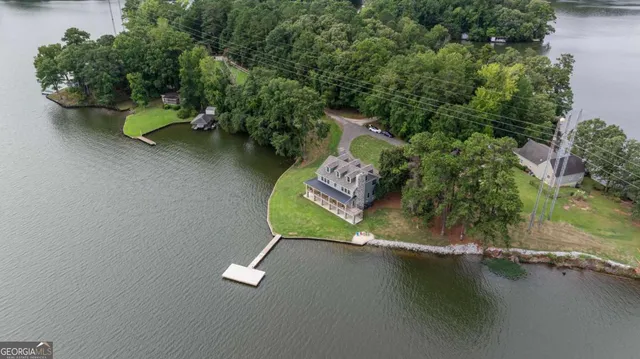 an aerial view of a house with a yard pool fire pit and outdoor seating