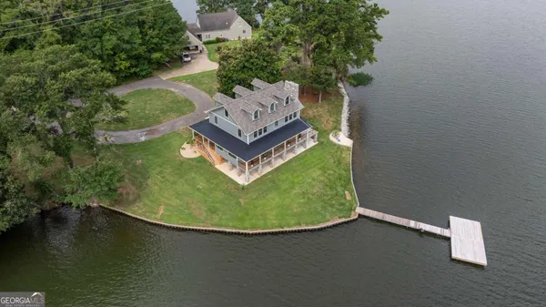 an aerial view of a house with a yard