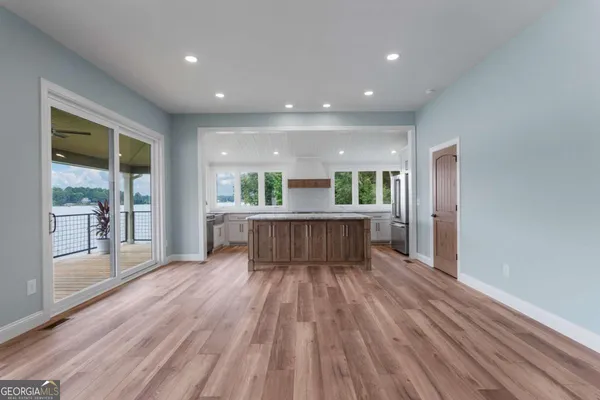 a view of kitchen with wooden floor and large window