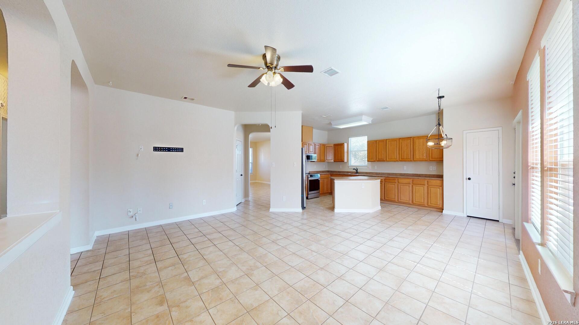 101 Springtree Cliff Cibolo, TX 78108 - Photo 12 of 46 a view of a kitchen with furniture and a ceiling fan