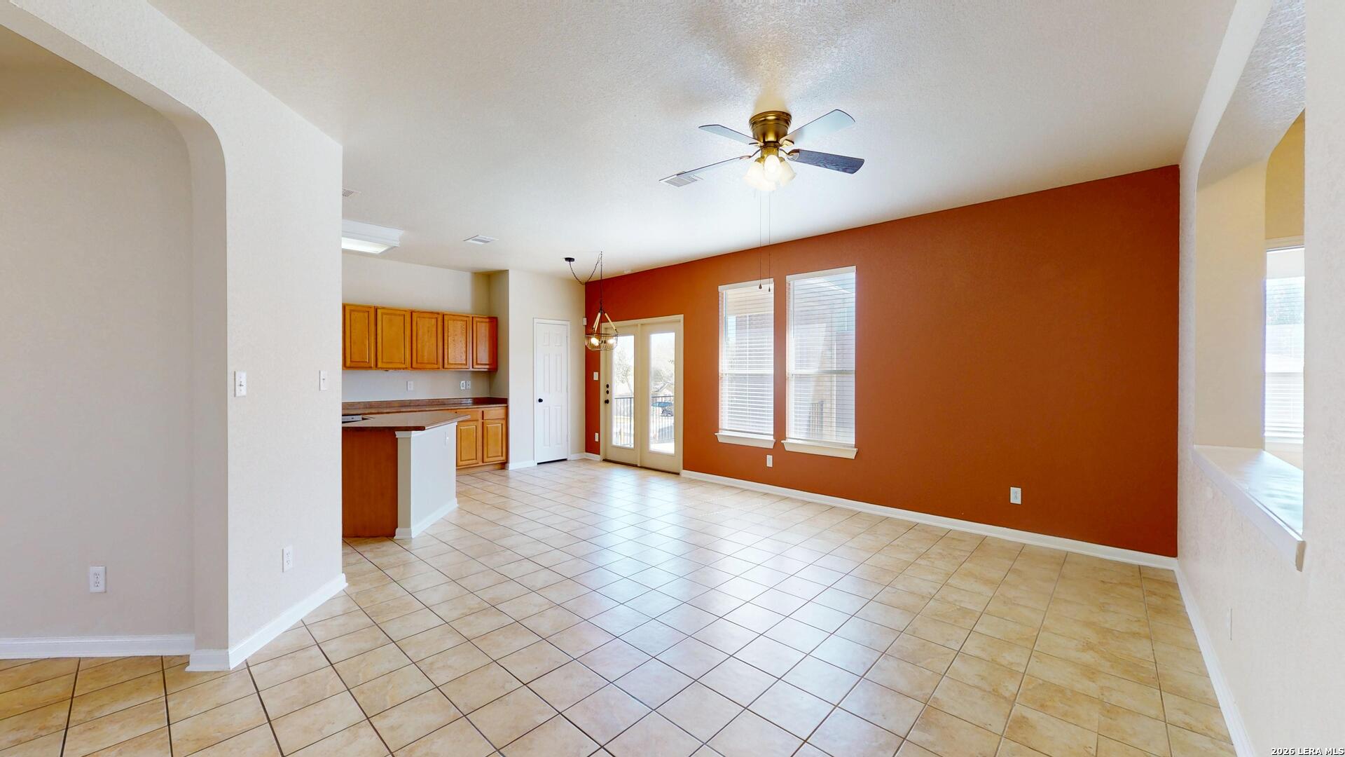 101 Springtree Cliff Cibolo, TX 78108 - Photo 13 of 46 a view of an empty room with window and wooden floor