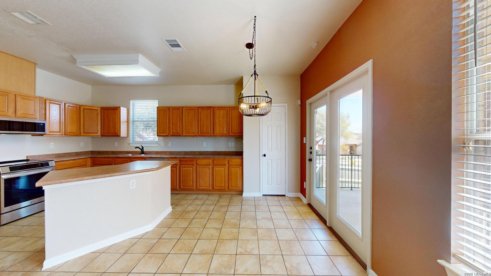 101 Springtree Cliff Cibolo, TX 78108 - Photo 14 of 46 a large kitchen with stainless steel appliances granite countertop a stove and a sink