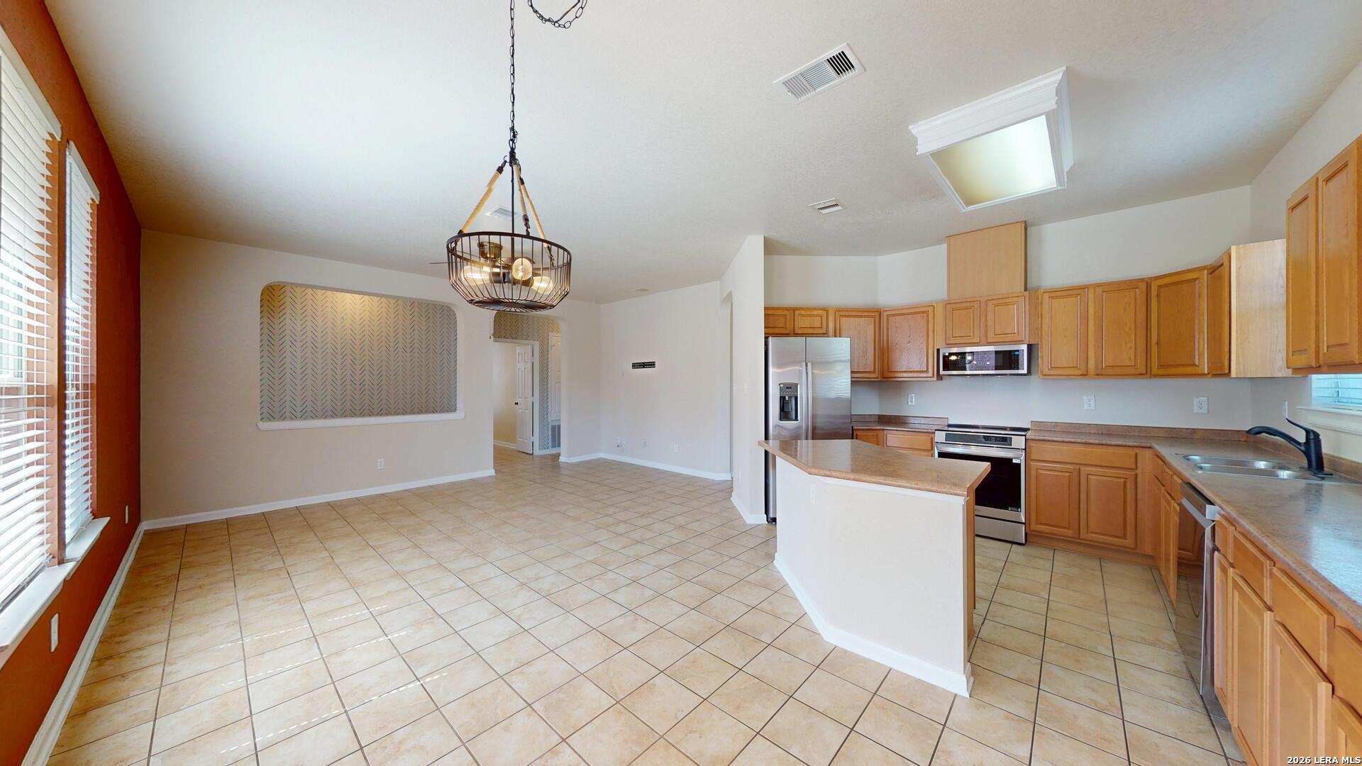 101 Springtree Cliff Cibolo, TX 78108 - Photo 15 of 46 a kitchen with stainless steel appliances granite countertop a stove top oven a sink a counter space and cabinets