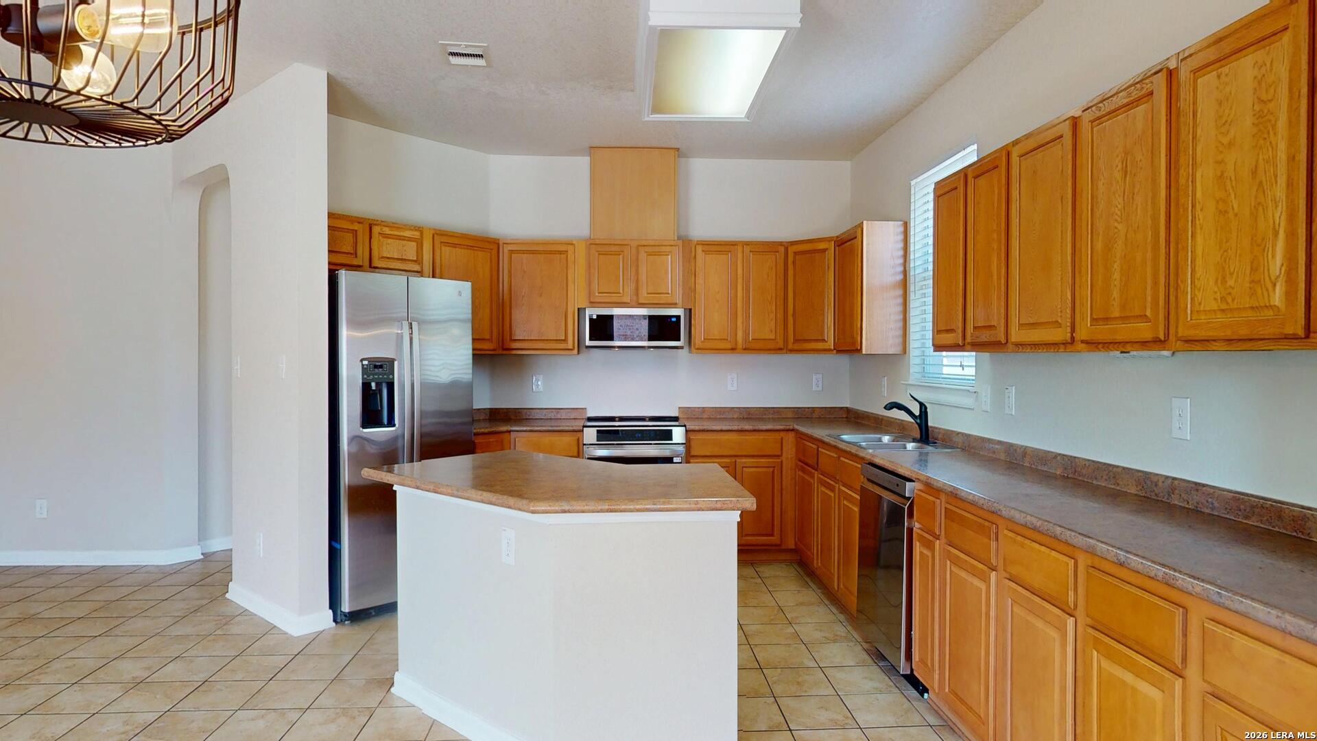 101 Springtree Cliff Cibolo, TX 78108 - Photo 17 of 46 a kitchen with stainless steel appliances granite countertop a sink stove and refrigerator