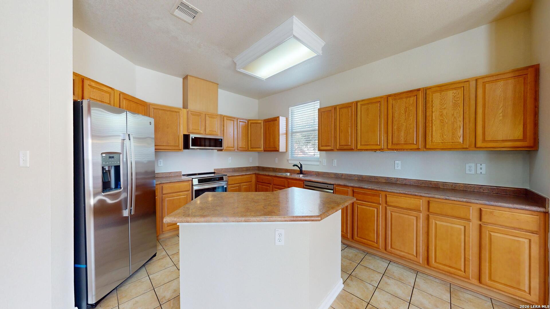 101 Springtree Cliff Cibolo, TX 78108 - Photo 18 of 46 a kitchen with stainless steel appliances granite countertop a sink a stove and cabinets